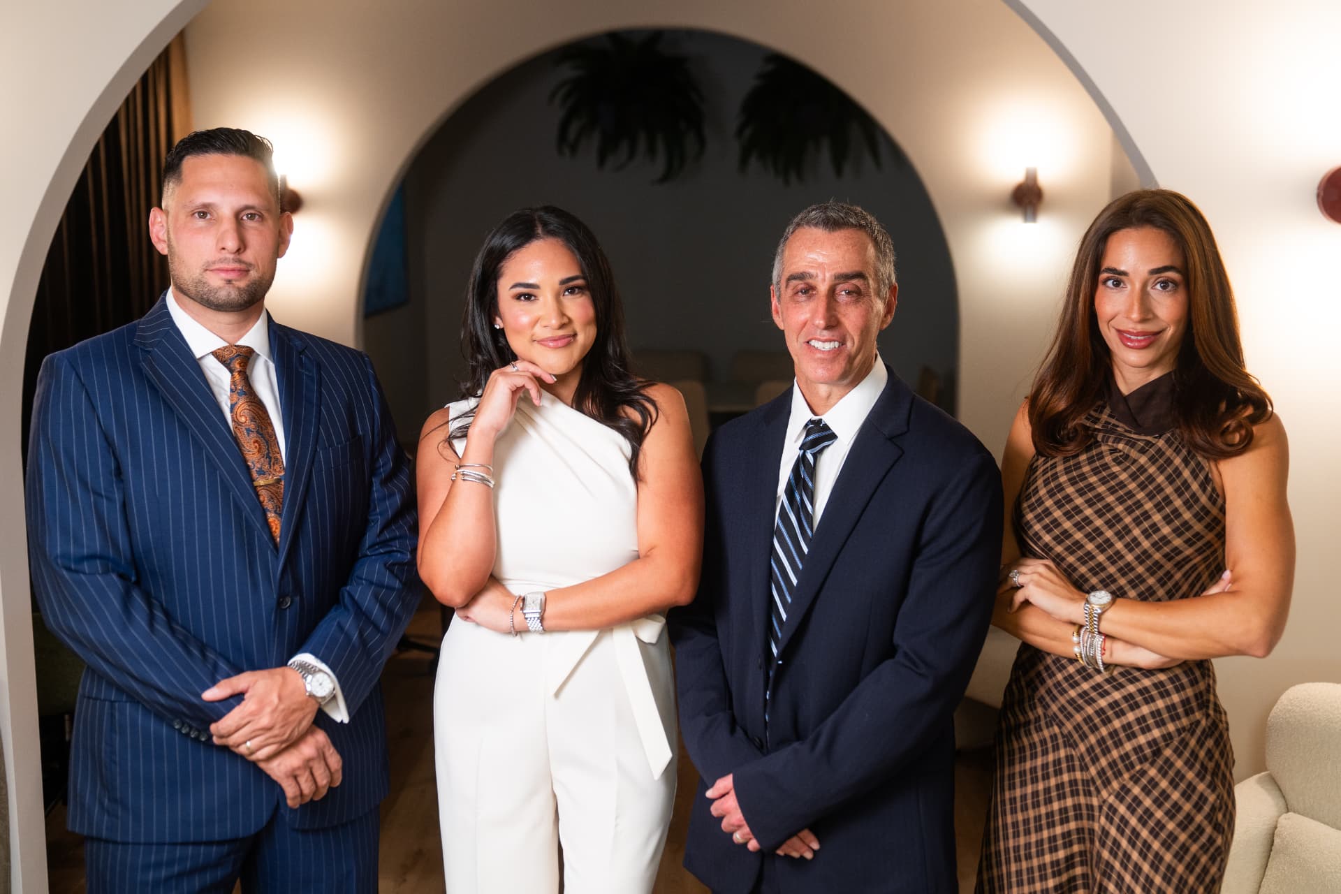 The Veritas Law Group team standing together in the firm's Miami office